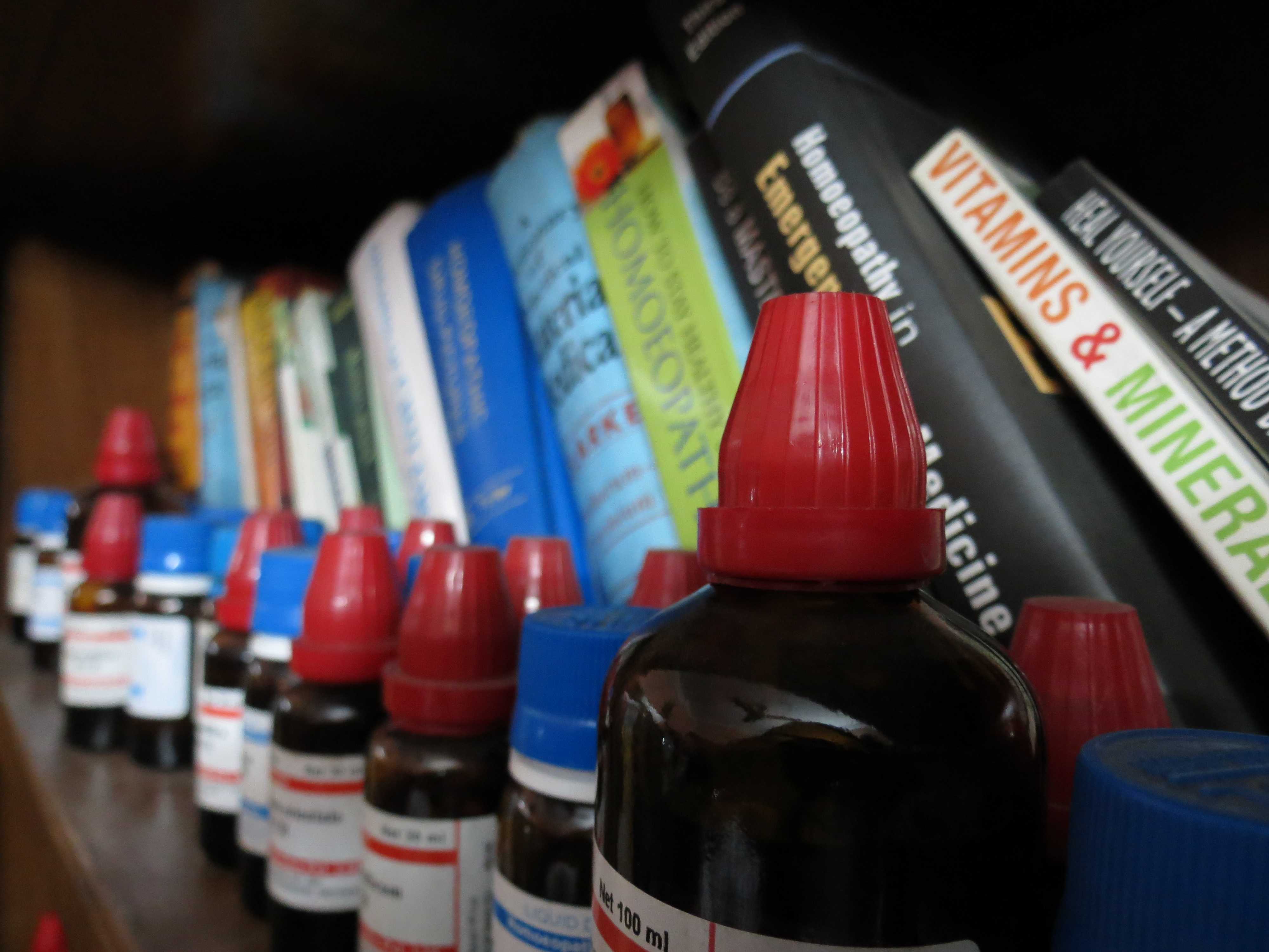 Homeopathic medicines and books on a shelf